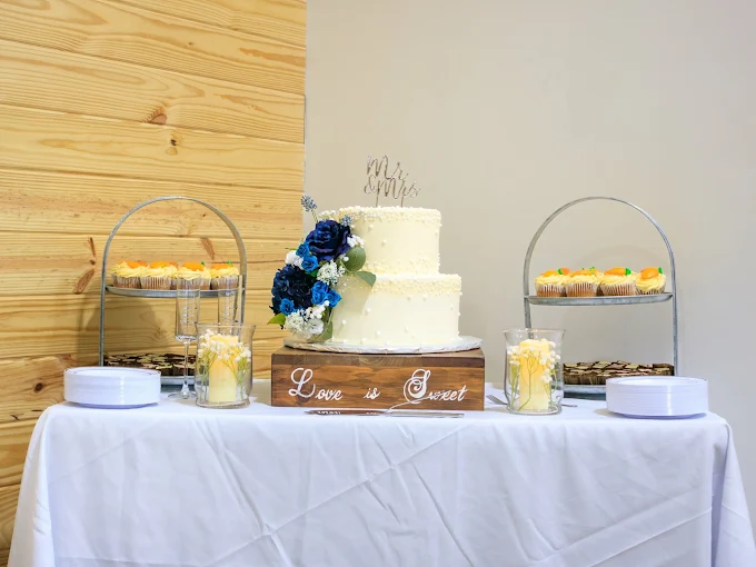 A wedding cake and dessert display at The Landing