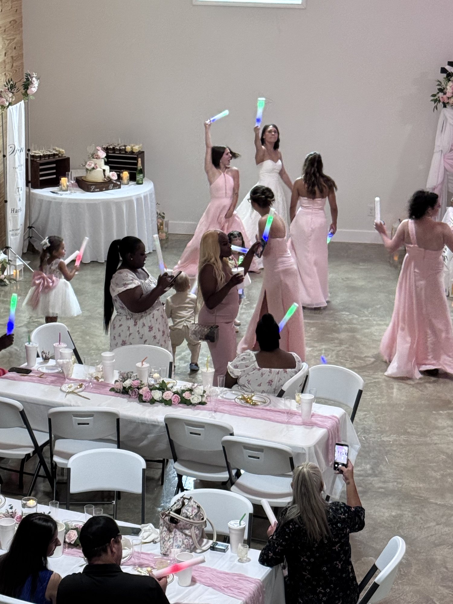 A wedding party and guests celebrating on The Landing’s dance floor